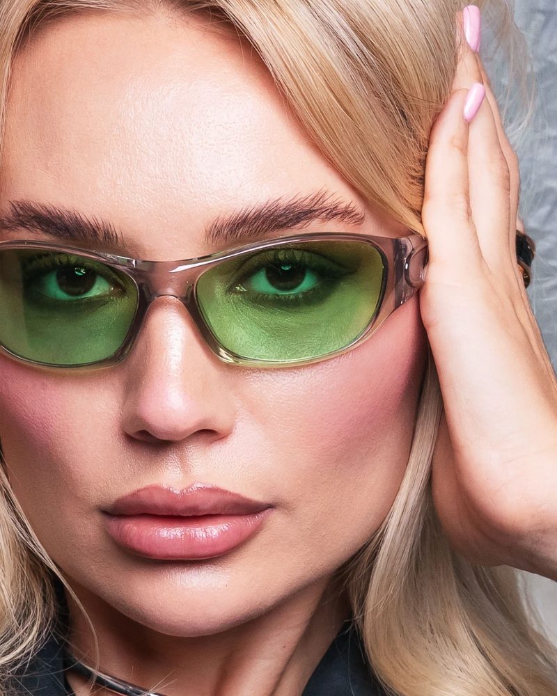Close-up beauty portrait in green tinted sunglasses