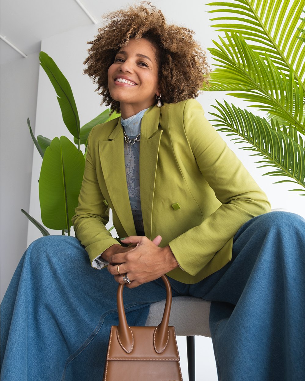 Lifestyle portrait in a green blazer among plants