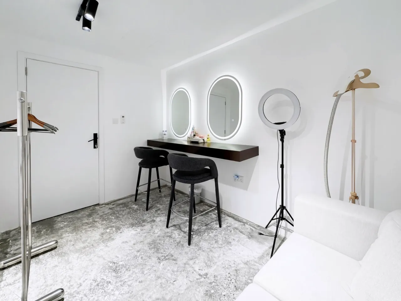 The dressing room with a sofa and clothing rail